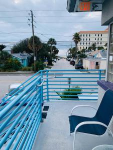 a blue railing on a porch with a bench at Royal North Beach in Clearwater Beach