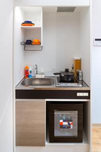 a kitchen with a sink and a stove at Popway Residence Tennoji in Osaka