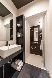 a bathroom with a sink and a shower at Popway Residence Tennoji in Osaka