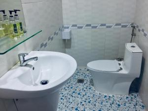 a bathroom with a white toilet and a sink at Eden House & Coffee Con Dao in Con Dao