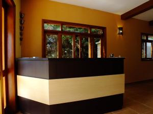 a kitchen with a counter and a window at Pousada Vista da Serra Monte Verde in Monte Verde
