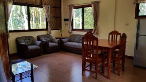 a living room with a table and a couch at Paco's Garden Home Stay in Mambajao