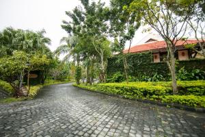 a cobblestone road in front of a house at Son Tra Resort & Spa Danang in Da Nang
