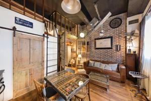 a living room with a brick wall and a couch at Les Petites Suites Dieppoises - Le Petit Prince A Dit in Dieppe