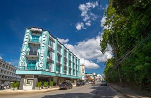 a blue building on the side of a street at Green House Hotel in Krabi town