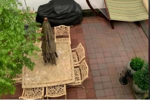 a table and chairs with an umbrella on a patio at Studio Apartment in Irvington