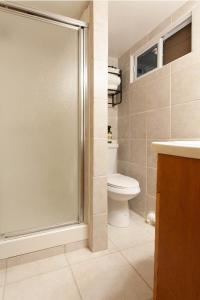 a bathroom with a shower and a toilet at Studio Apartment in Irvington