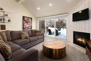 a living room with a couch and a fireplace at Three Kings by White Pines in Park City