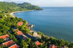 an aerial view of a beach with palm trees and houses at Son Tra Resort in Danang