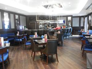 a restaurant with tables and chairs and a bar at Crowne Plaza Istanbul Oryapark by IHG in Istanbul