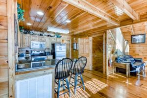 a kitchen with two chairs at a counter in a cabin at Vista Point in Pigeon Forge