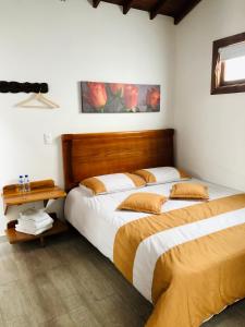 Postel nebo postele na pokoji v ubytování 40 Amigos Hotel