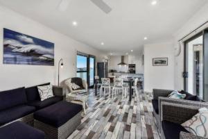 a living room with a couch and a table at Plovers Rest at Cape Douglas in Cape Douglas