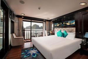 a bedroom with a large white bed and a balcony at Alisa Premier Cruise in Ha Long +55 photos