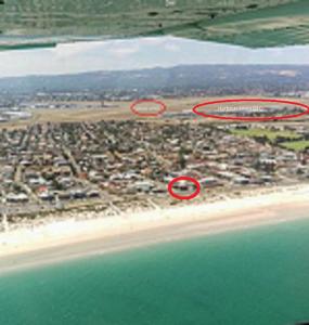 two red circles on a beach with a city at Acushla Accommodation Esplanade Living Self Check-In Self Check-Out in Adelaide