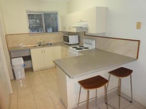 a kitchen with a counter and two stools at Townsville Terrace in Townsville