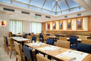 a large dining room with tables and chairs at Holiday Inn Citystars by IHG in Cairo