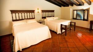 Un pat sau paturi într-o cameră la Meson del Alferez Coatepec