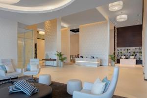 a lobby with chairs and a waiting room at Hyatt Place Dubai Jumeirah in Dubai