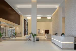 a lobby with a reception desk in a building at Hyatt Place Dubai Jumeirah in Dubai
