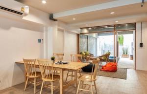 a dining room with a wooden table and chairs at Vann House Hua Hin in Hua Hin
