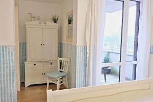 a bedroom with a cabinet and a chair and a window at Albatros in Stein