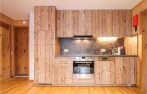 a kitchen with wood paneled walls and an oven at Stunning Apartment In Dalaas With 2 Bedrooms And Wifi in Dalaas
