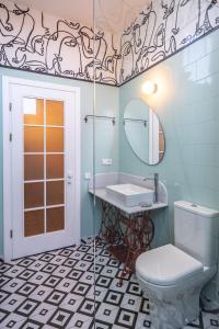 a bathroom with a sink and a toilet and a mirror at Cozy Baity Tbilisi in Tbilisi City +100 photos