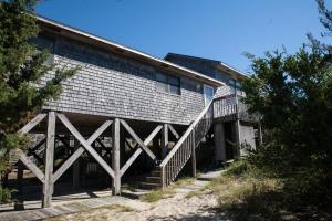 a building with a staircase leading up to it at 40399 Beachcomber Rd Home in Avon