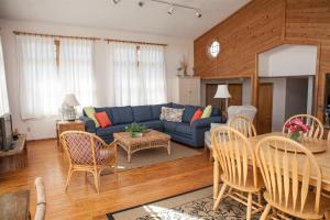 a living room with a blue couch and a table at 40399 Beachcomber Rd Home in Avon +8 photos