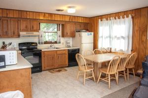 a kitchen with a table and chairs and a refrigerator at Shoresurf House 54227 in Frisco