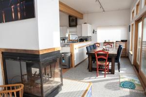 a kitchen and dining room with a fireplace and a table at THE SUNNY SPOT cottage in Frisco +15 photos