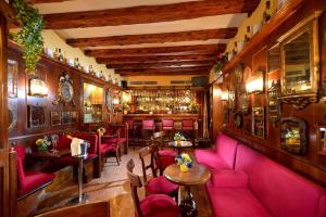 a restaurant with pink chairs and tables and a bar at Antico Panada in Venice