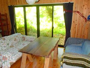 Postel nebo postele na pokoji v ubytování 屋久島コテージ対流山荘 + 11 fotografií
