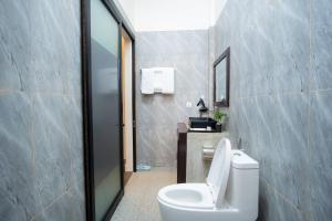 a bathroom with a white toilet and a mirror at Sala Kanseng Home in Siem Reap +45 photos
