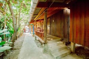 a wooden house with stairs leading up to it at Molina Bungalows in Vang Vieng