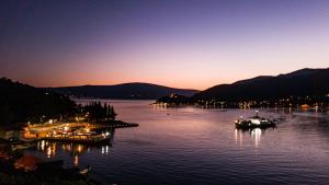 a view of a lake at night with boats in the water at Apartments Eftimov in Tivat