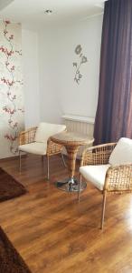 a living room with two chairs and a table at Mosilor Apartments in Bucharest