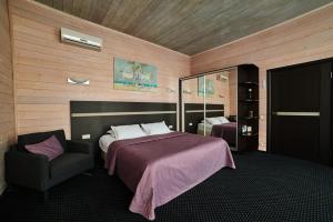 Ein Bett oder Betten in einem Zimmer der Unterkunft Отель Арт-Ульяновск Левый берег