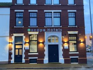 a brick building with the words escape hotels on it at Escape Hotel in Barrow in Furness