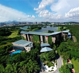an aerial view of a building with a river at Shenzhen Castle Hotel in Longgang