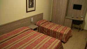 Letto o letti in una camera di Hotel Due Pini