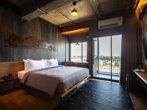 Postel nebo postele na pokoji v ubytování Navakitel Design Hotel