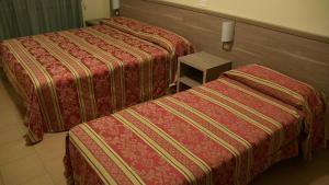 Letto o letti in una camera di Hotel Due Pini