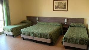 Letto o letti in una camera di Hotel Due Pini