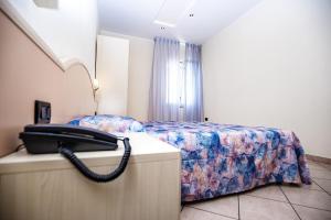 A bed or beds in a room at Hotel Sileoni Dépendance Villa Antonio