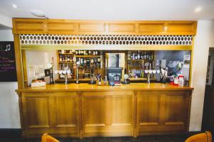 a kitchen with wooden cabinets and a counter top at The Kings Arms in Shap