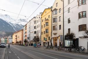 a street in a city with buildings and bikes at Basic Apartments downtown in Innsbruck