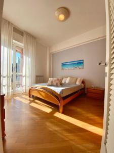 a bedroom with a bed and a large window at Maison de Mauri in San Terenzo