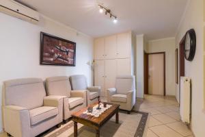 a living room with a couch and chairs and a table at Tatiana Seaview House by Konnect, Nisaki in Nisakion